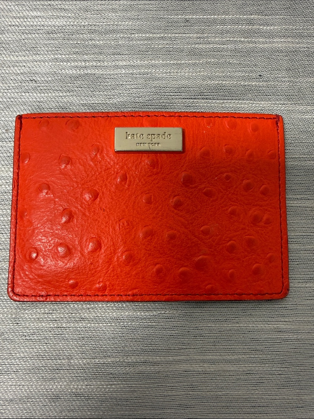 kate spade orange embossed card case with gold plaque
